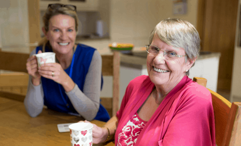 aged care funding - nurse with elder lady having tea-v2