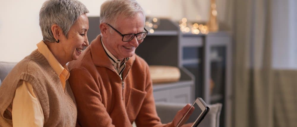 Elder couple looking at tablet