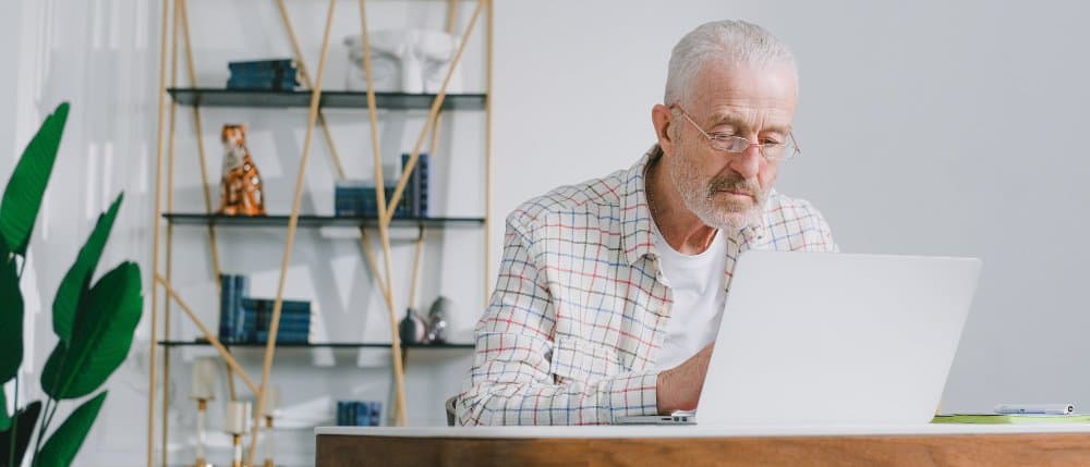 Senior men using laptop