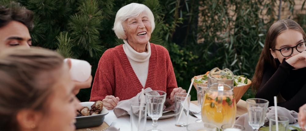 Elder pensioner having lunch with family