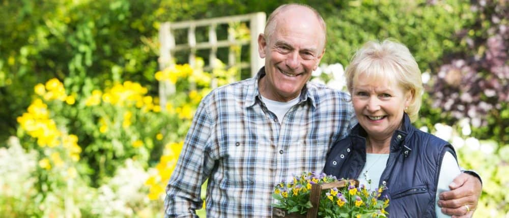 Older couple holding flowers
