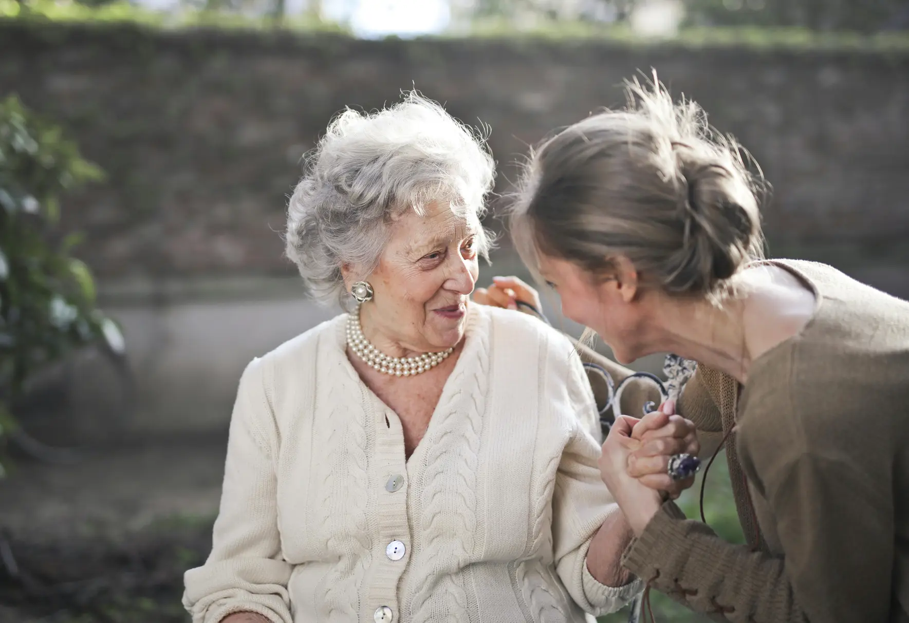 Two woman talking in a garden